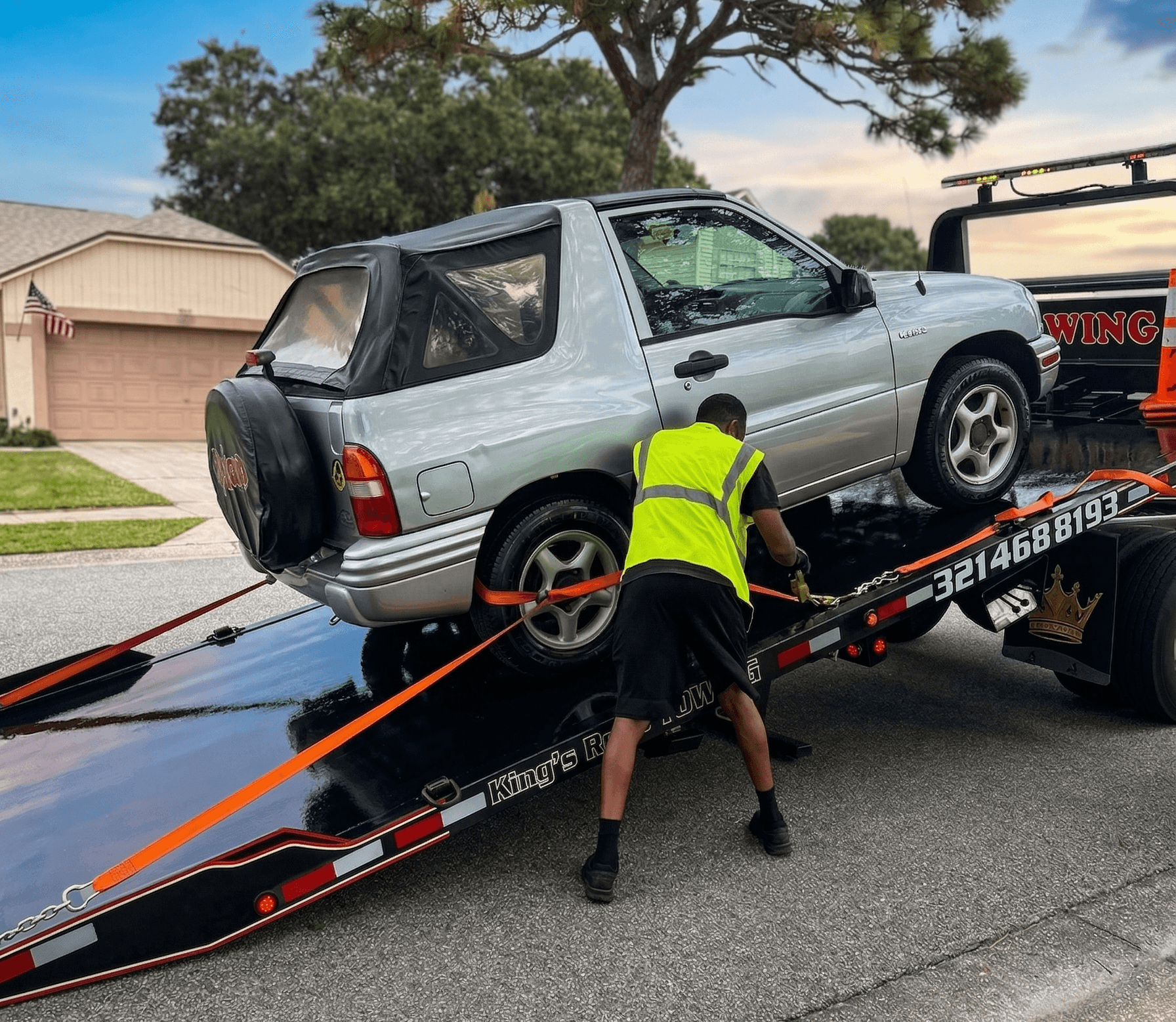 White truck loaded on flatbed driving on highway