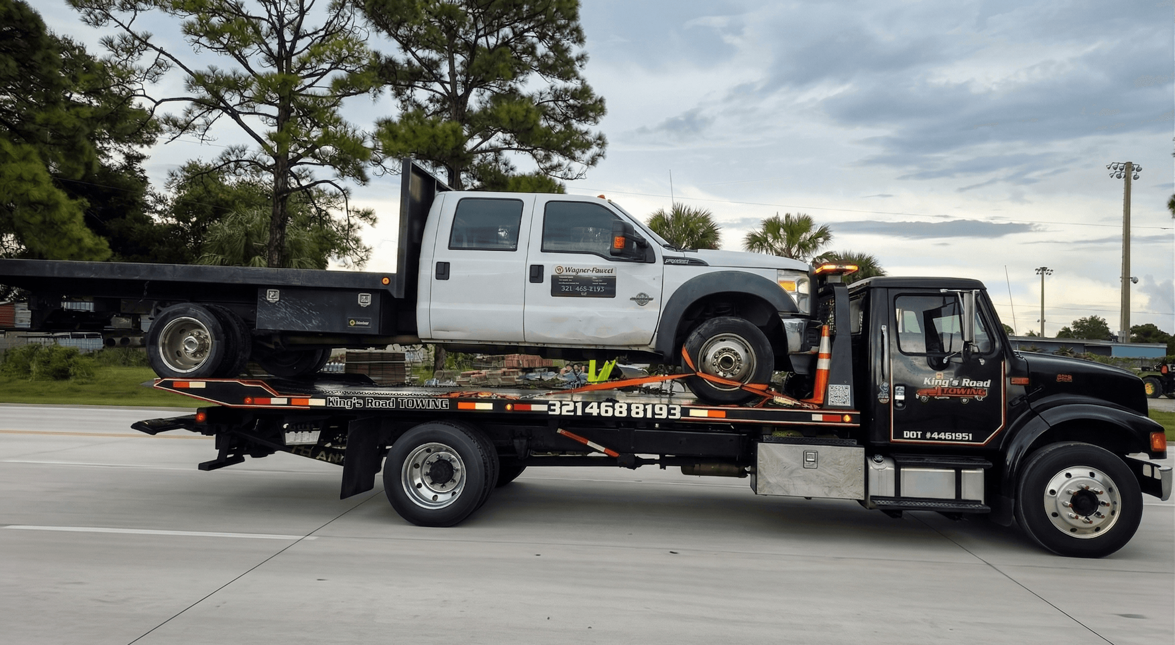 White Cadillac Escalade close-up on flatbed tow truck