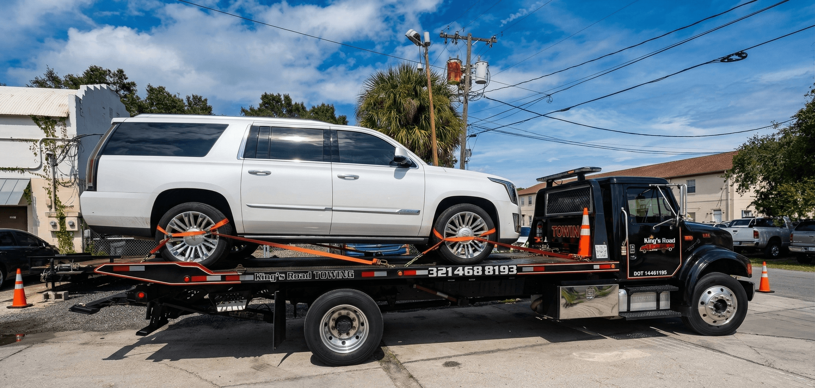 Dark SUV secured on flatbed at night